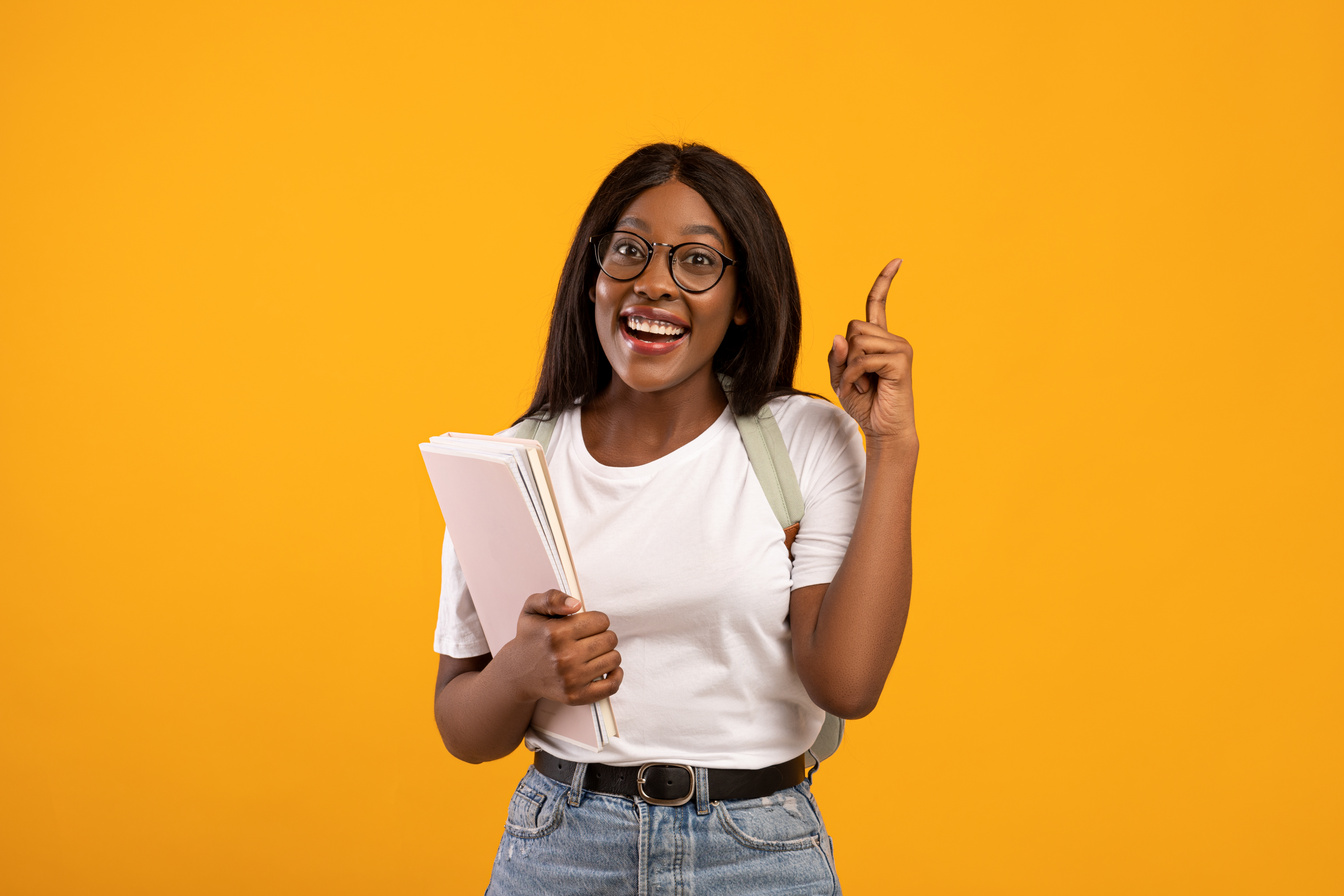 Inspired black woman student raising finger up, having idea